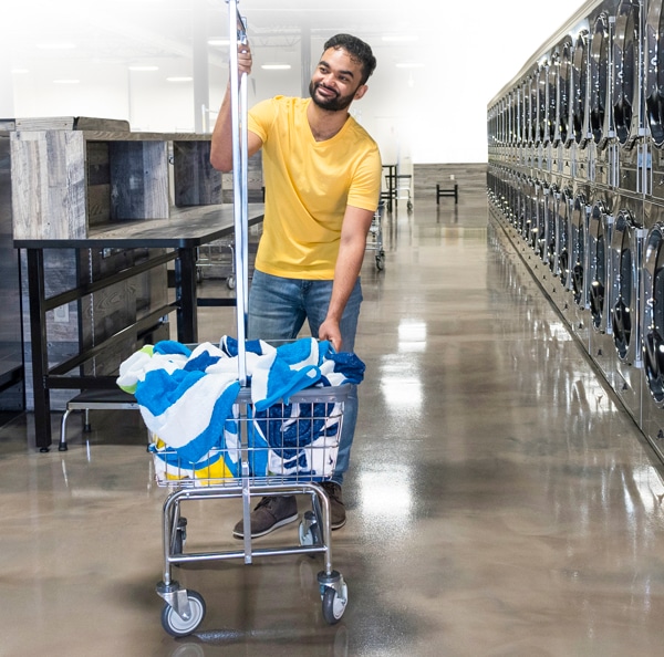 Laundry Cart Safety Tips. Man properly using a laundry cart.