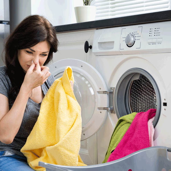 Clothes Smell After Washing. Woman Holding Nose.