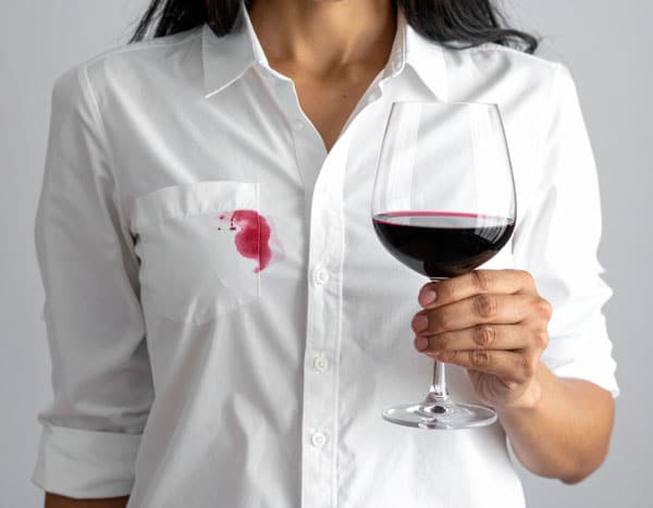Stain Removal. Woman with wine on her shirt